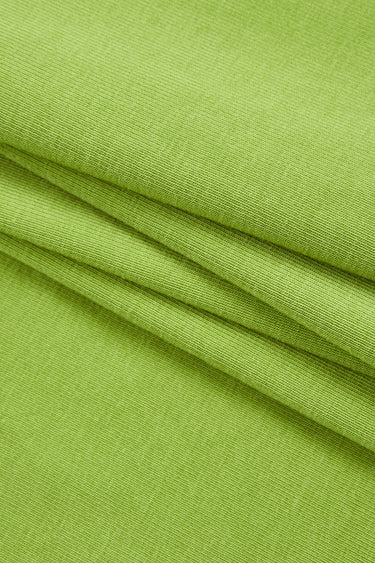 Cotton spandex stretch rib knit fabric close-up with folded drape detail for comfortable everyday apparel.