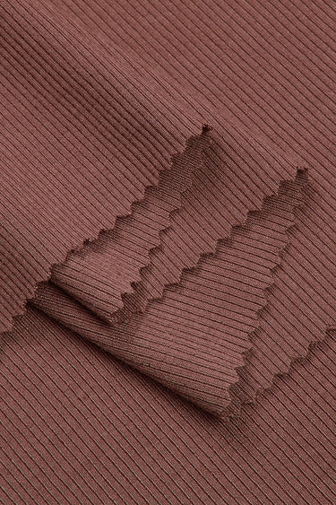 Viscose spandex stretch rib knit fabric close-up with layered fold detail and high elasticity for fitted knitwear and rib trims.