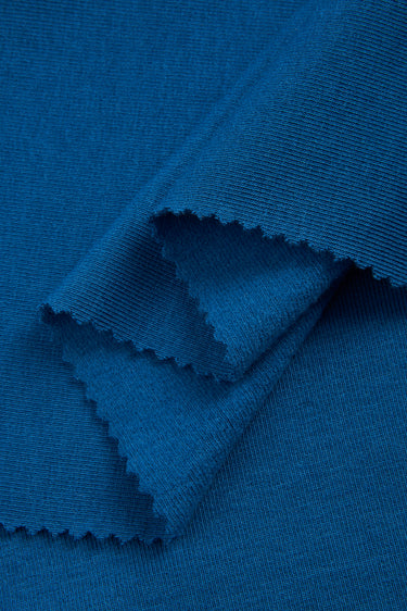 Mousse rib knit fabric close-up with smooth surface texture and soft hand feel for casual knitwear.