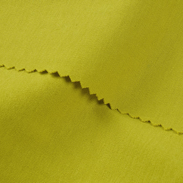 Long staple cotton double knit fabric close-up with edge structure detail and clean surface for light layering garments.