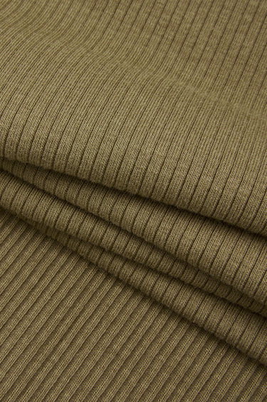 Cotton viscose spandex rib knit fabric close-up with surface fold detail and stretch texture for comfortable fitted garments.