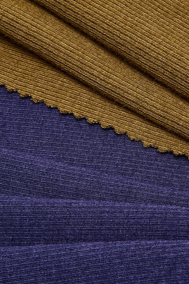 Viscose cotton spandex stretch rib knit fabric close-up with layered edge detail and smooth surface for everyday apparel.