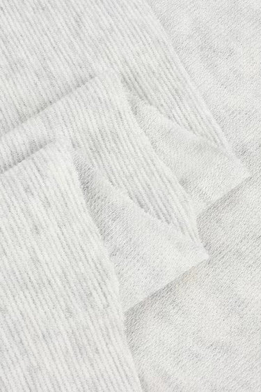 Ecocosy textured double-face step knit fabric close-up with layered fold detail and soft surface for transitional garments and structured knitwear.