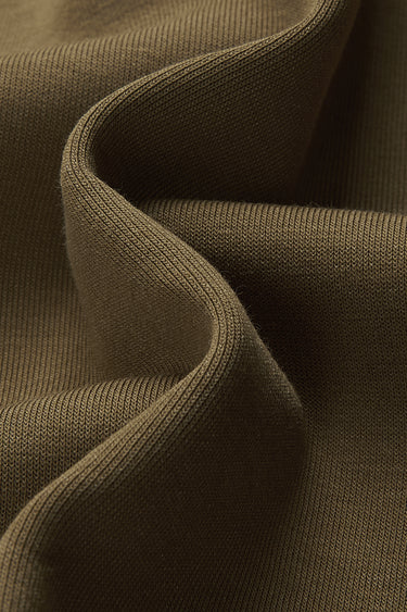 Cotton SCUBA spacer knit fabric close-up with curved drape detail and smooth texture for everyday garments.