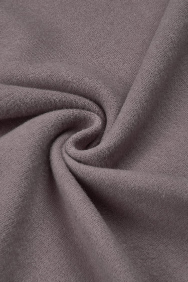 Double-sided stretch knit fabric close-up with twist detail and soft texture for cool-season knitwear.
