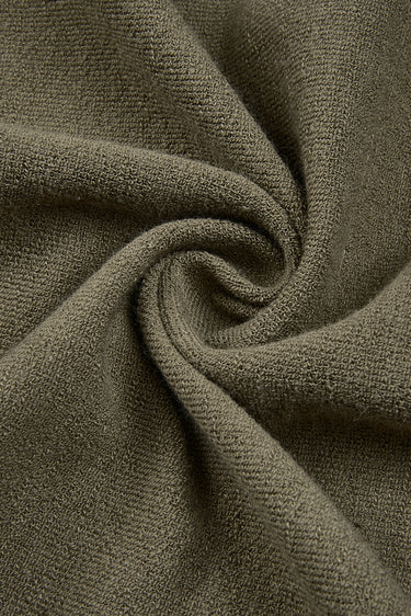Cotton polyester terry knit fabric close-up with twist detail and soft terry texture for casualwear and sportswear.