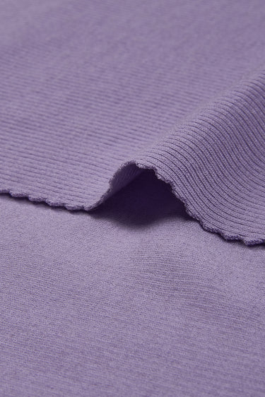 Merino wool elastane double-face rib knit fabric close-up with edge structure detail and soft thermal comfort for mild cool-weather knitwear.