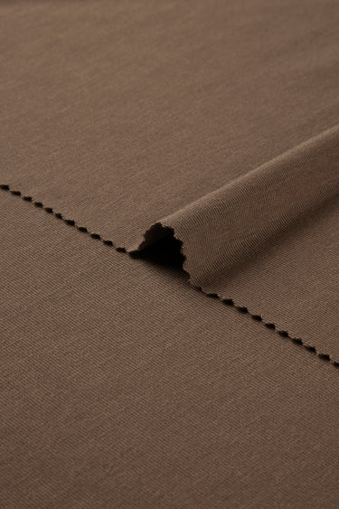 Rayon nylon blend stretch rib knit fabric close-up with edge structure detail and soft dry touch for everyday garments.
