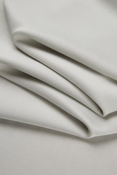 Lenzing modal double-face rib knit fabric close-up with folded drape detail and smooth dry touch for modern everyday apparel.
