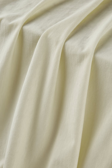 Cotton blend stretch single jersey fabric close-up with surface drape detail and soft dry touch for base layers and underwear.