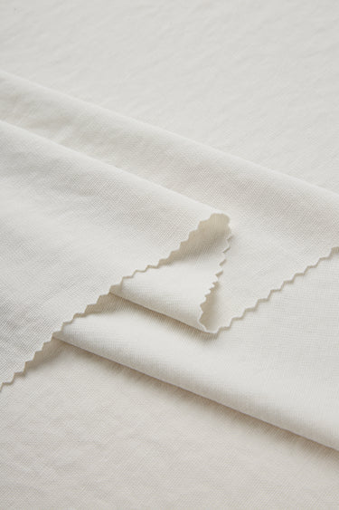 Sand-washed Lenzing modal stretch double knit fabric close-up with folded edge detail for modern knitwear and everyday lifestyle garments.