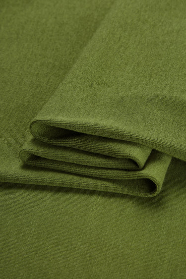 Merino cashmere blend mousse knit fabric close-up with folded stack detail for modern casualwear and soft knit garments.