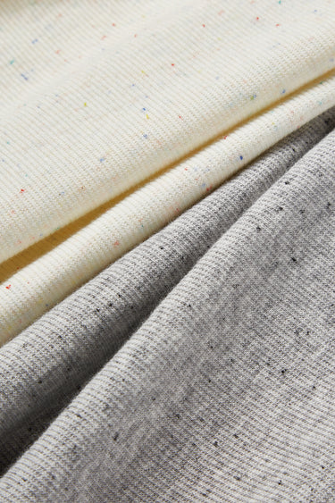 Mousse rib knit fabric close-up with diagonal layer detail and smooth hand feel for comfortable knit garments.