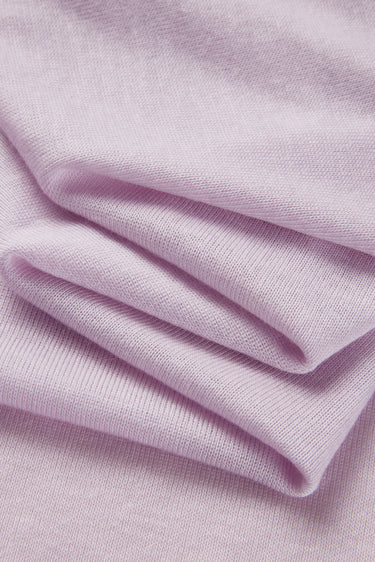 TENCEL wool blend stretch rib knit fabric close-up with folded drape detail for premium base layers and soft knit garments.