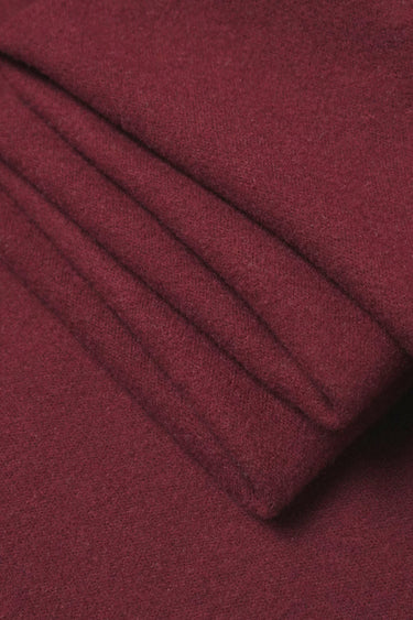 Wool blend mousse knit fabric close-up with folded detail and soft micro-fleece texture for modern casualwear.