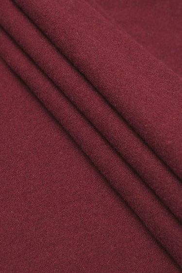 Wool blend mousse knit fabric close-up with layered fold detail and soft texture for casual knitwear.