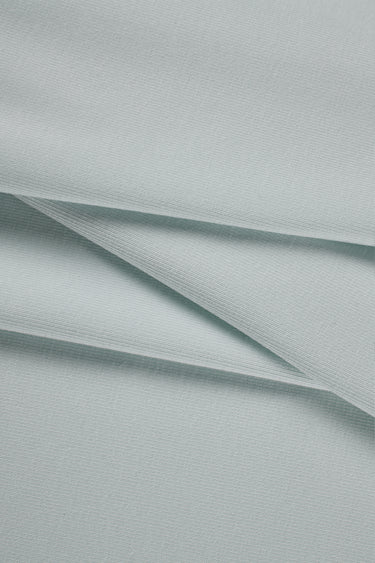 Mousse rib knit fabric close-up with smooth surface texture for modern casualwear and knit garments.