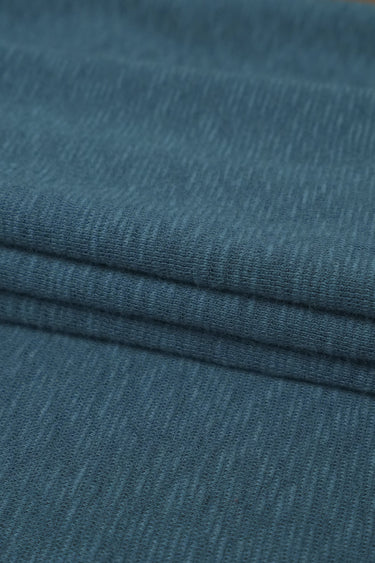 Bamboo slub mousse knit fabric close-up with subtle irregular surface texture for comfortable knit garments.