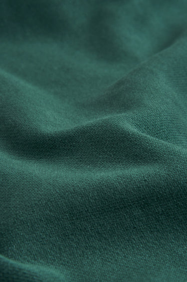 Sand-washed stretch double knit fabric close-up with soft surface drape for modern knitwear and sweatshirts.