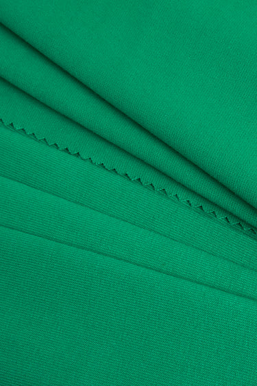 TENCEL linen blend single jersey fabric close-up with folded detail and natural dry texture for lightweight tops and summer knitwear.