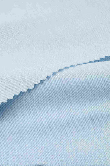 Lycra TENCEL wool stretch rib knit fabric close-up with folded edge detail for next-to-skin comfort and lightweight base layers.