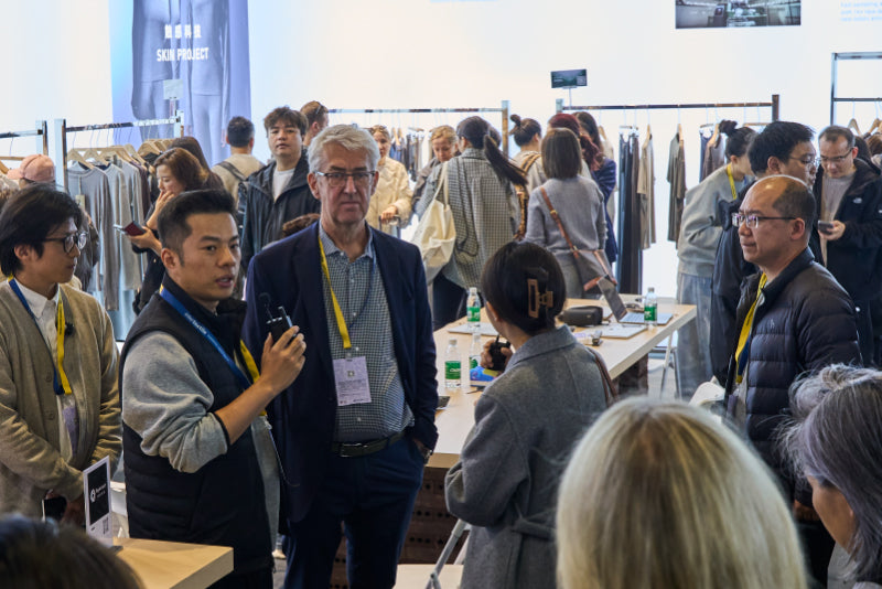 Regen-tech Fashion team presenting knit fabric collections to visitors at Intertextile Shanghai.
