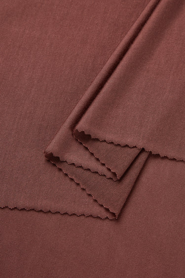 Lenzing TENCEL Lyocell single jersey fabric close-up with layered fold detail and elegant drape for premium summer collections.