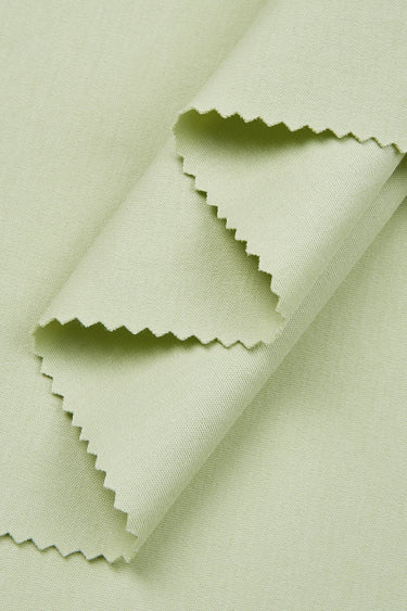 Cotton interlock knit fabric close-up with layered fold detail and clean surface for modern casual garments.