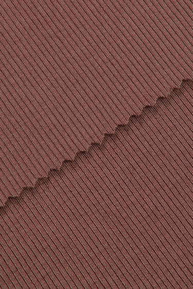 Viscose spandex stretch rib knit fabric close-up with edge structure detail for close-to-body comfort and everyday garments.