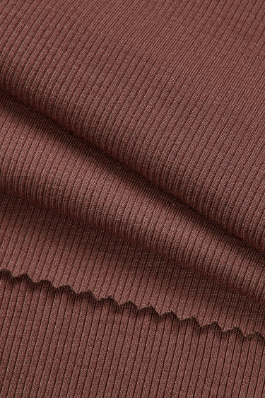 Viscose spandex stretch rib knit fabric close-up with surface fold detail and flexible recovery for comfortable fitted apparel.