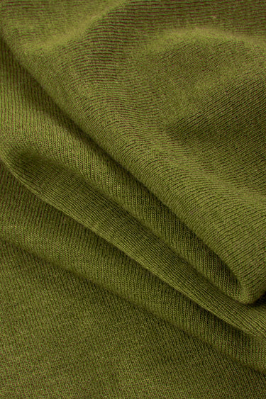 Mousse acrylic cashmere rib knit fabric close-up with folded drape detail for refined casualwear and soft knit garments.