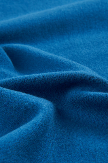 Mousse rib knit fabric close-up with twist detail and soft texture for modern casualwear.