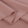 Viscose-covered filament single jersey fabric close-up with folded edge detail and smooth hand feel for base layers and everyday knit garments.