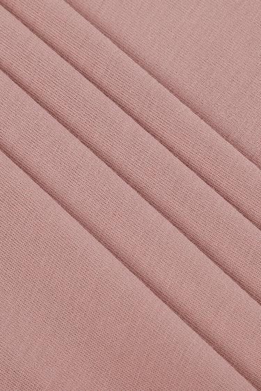 Viscose-covered filament single jersey fabric close-up with surface fold detail and clean texture for versatile everyday knit garments.