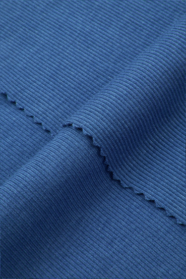 Cotton modal spandex stretch rib knit fabric close-up with folded edge detail for comfortable base layers and everyday apparel.