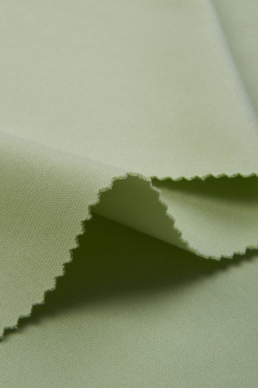 Cotton polyester interlock knit fabric close-up with edge structure detail and clean surface for modern casual garments.