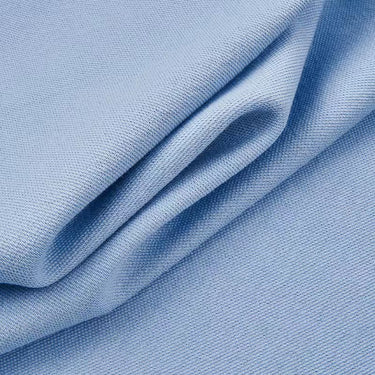 Cotton polyester textured mesh knit fabric close-up with folded drape detail and smooth hand feel for structured knit garments.