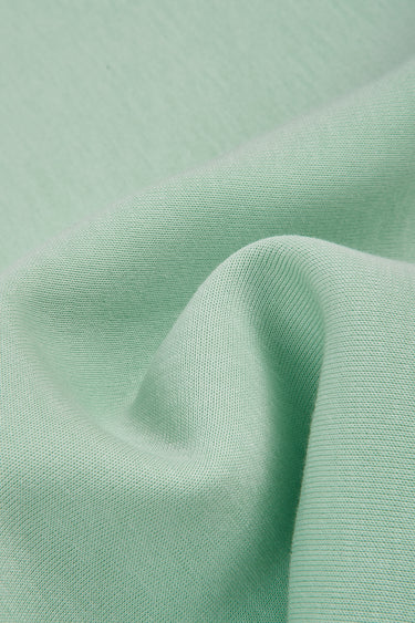 Jelly air-layer SCUBA knit fabric close-up with dimensional drape detail and springy structure for refined knit garments.