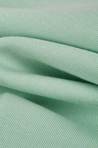 Jelly air-layer SCUBA knit fabric close-up with folded drape detail and breathable volume for modern casualwear.