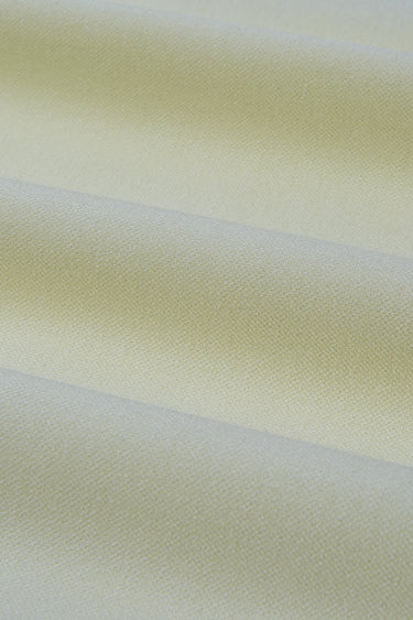 Double-sided piqué knit fabric close-up with surface fold detail and smooth hand feel for structured knit garments.