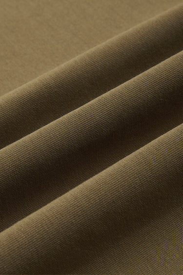 Cotton SCUBA spacer knit fabric close-up with surface fold detail and structured comfort for refined casualwear.