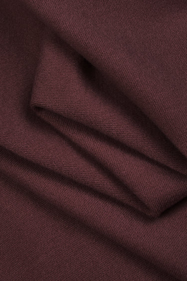 Ecocosy antibacterial acrylic cashmere fleece knit fabric close-up with folded drape detail for casual knitwear and everyday comfort.