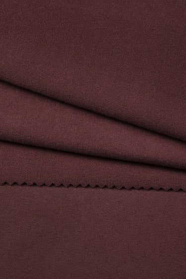 Ecocosy antibacterial acrylic cashmere fleece knit fabric close-up with surface fold detail and smooth hand feel for comfortable knit garments.