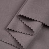 Double-sided stretch knit fabric close-up with layered fold detail for layering garments and cool-season knitwear.