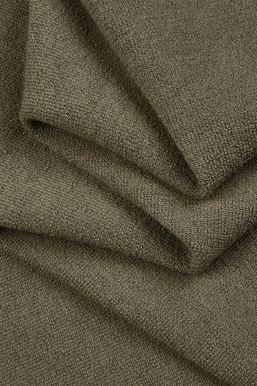Cotton polyester terry knit fabric close-up with folded drape detail for casualwear and everyday garments.