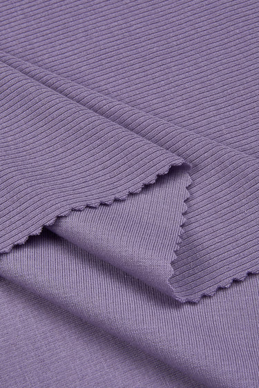 Merino wool elastane double-face rib knit fabric close-up with folded edge detail and stable structure for modern knit garments.