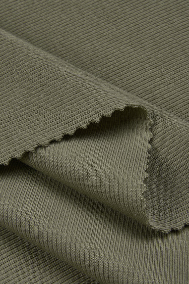 Mousse cashmere warm stretch rib knit fabric close-up with folded edge detail and smooth hand feel for cool-season apparel.