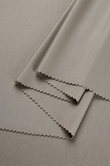 Lenzing modal double-face rib knit fabric close-up with folded edge detail and structured surface for refined everyday garments.