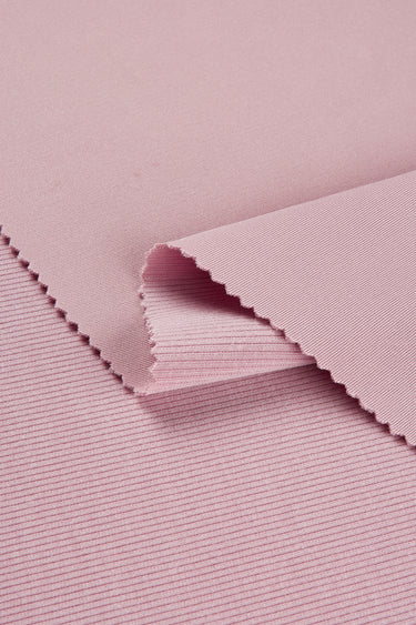 Lenzing modal double-face rib knit fabric close-up with layered fold detail and stable structure for refined silhouettes.