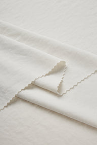 Sand-washed Lenzing modal stretch double knit fabric close-up with folded edge detail for modern knitwear and everyday lifestyle garments.
